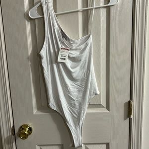2 one shoulder body suits tan and white